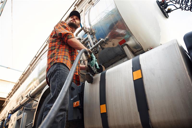 young truck driver in casual clothes is refueling 2023 11 27 05 31 36 utc